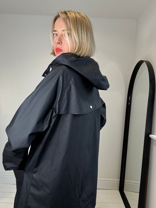 Rubber hooded rain mac