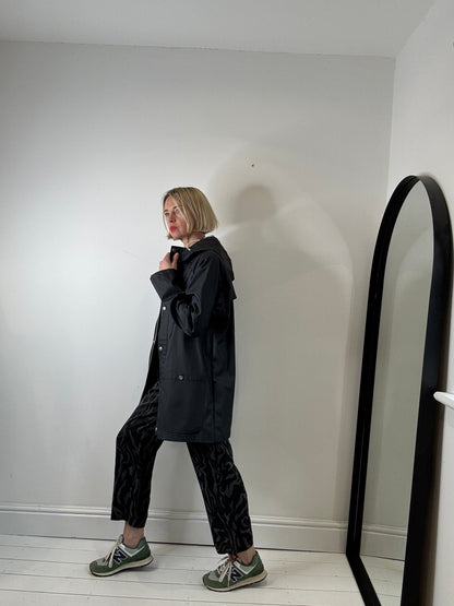 Rubber hooded rain mac