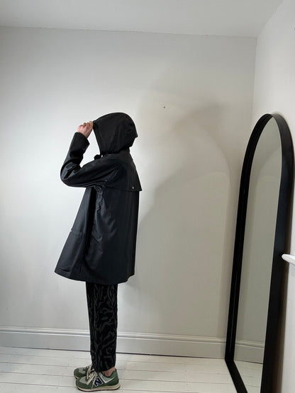 Rubber hooded rain mac