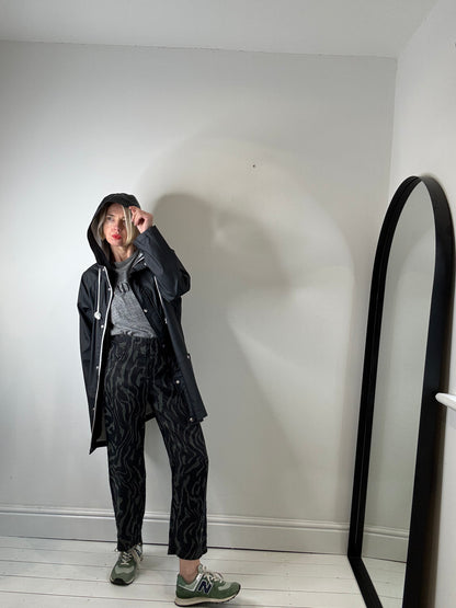 Rubber hooded rain mac