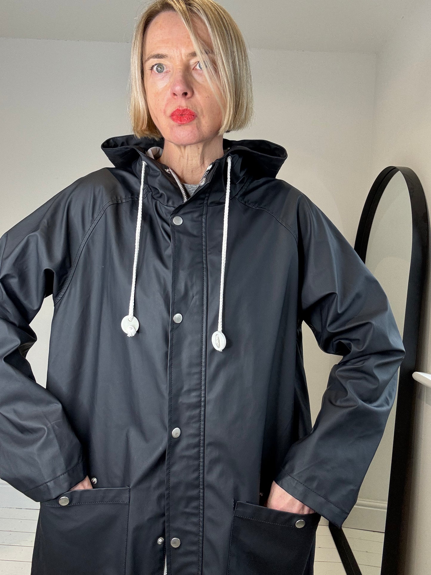 Rubber hooded rain mac