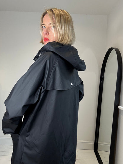 Rubber hooded rain mac